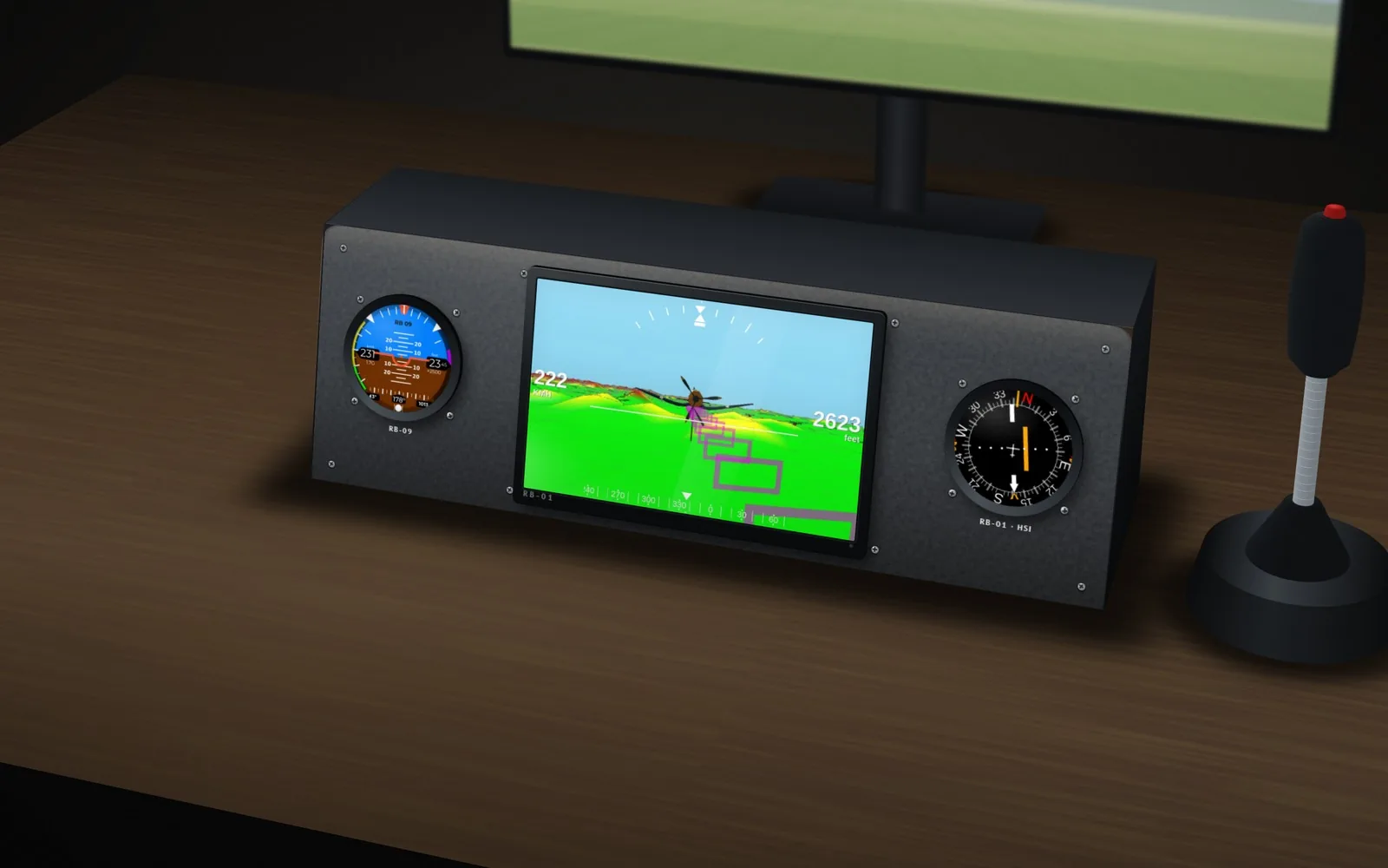 Desktop pod on a desk under the Flight Simulator monitor: an RB-09 attitude display, an RB-01 synthetic vision screen and an RB-01 HSI, with a joystick beside it